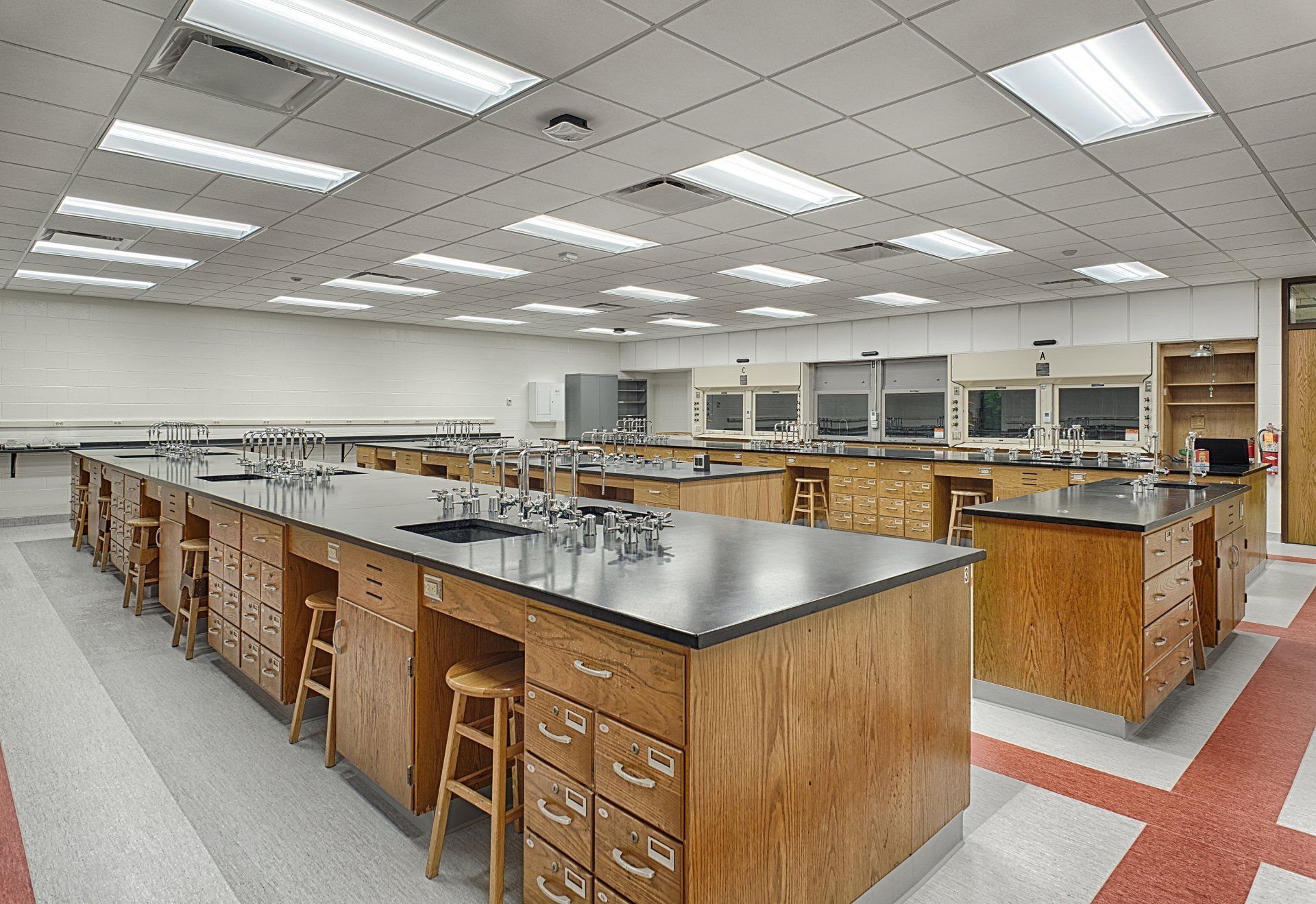 A large room with a lot of counters and stools