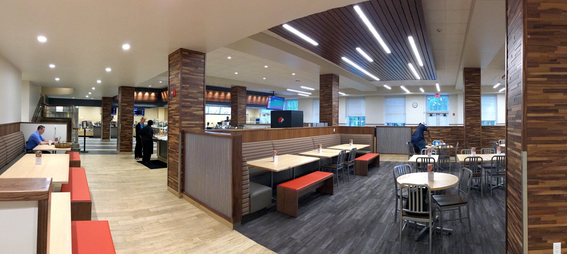 A large dining room with tables and benches in a restaurant.