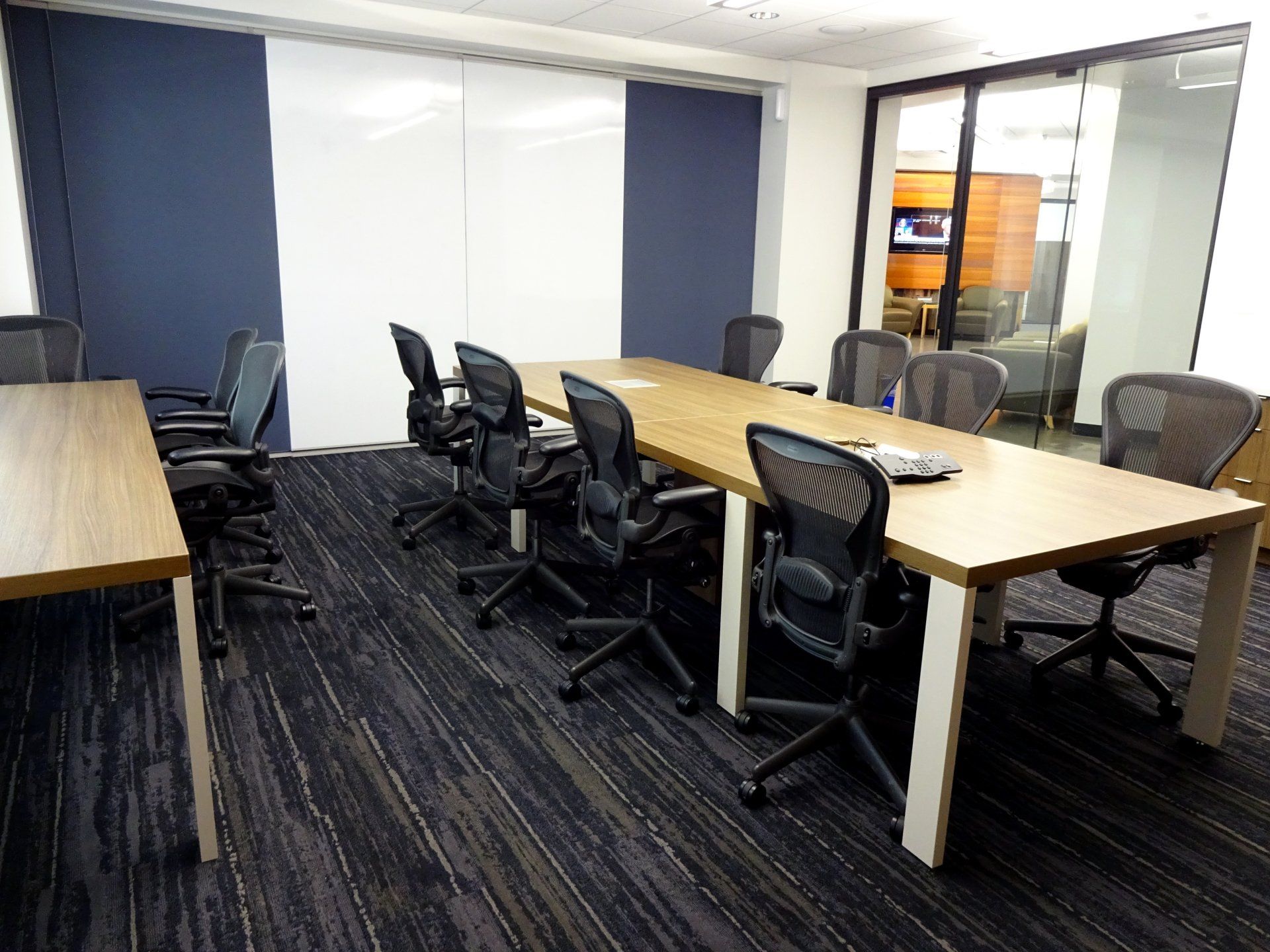 A conference room with a long table and chairs.