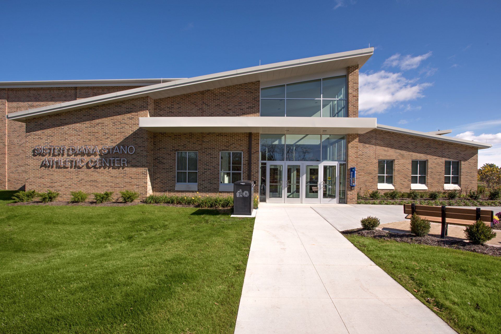 A large brick building with a walkway leading to it