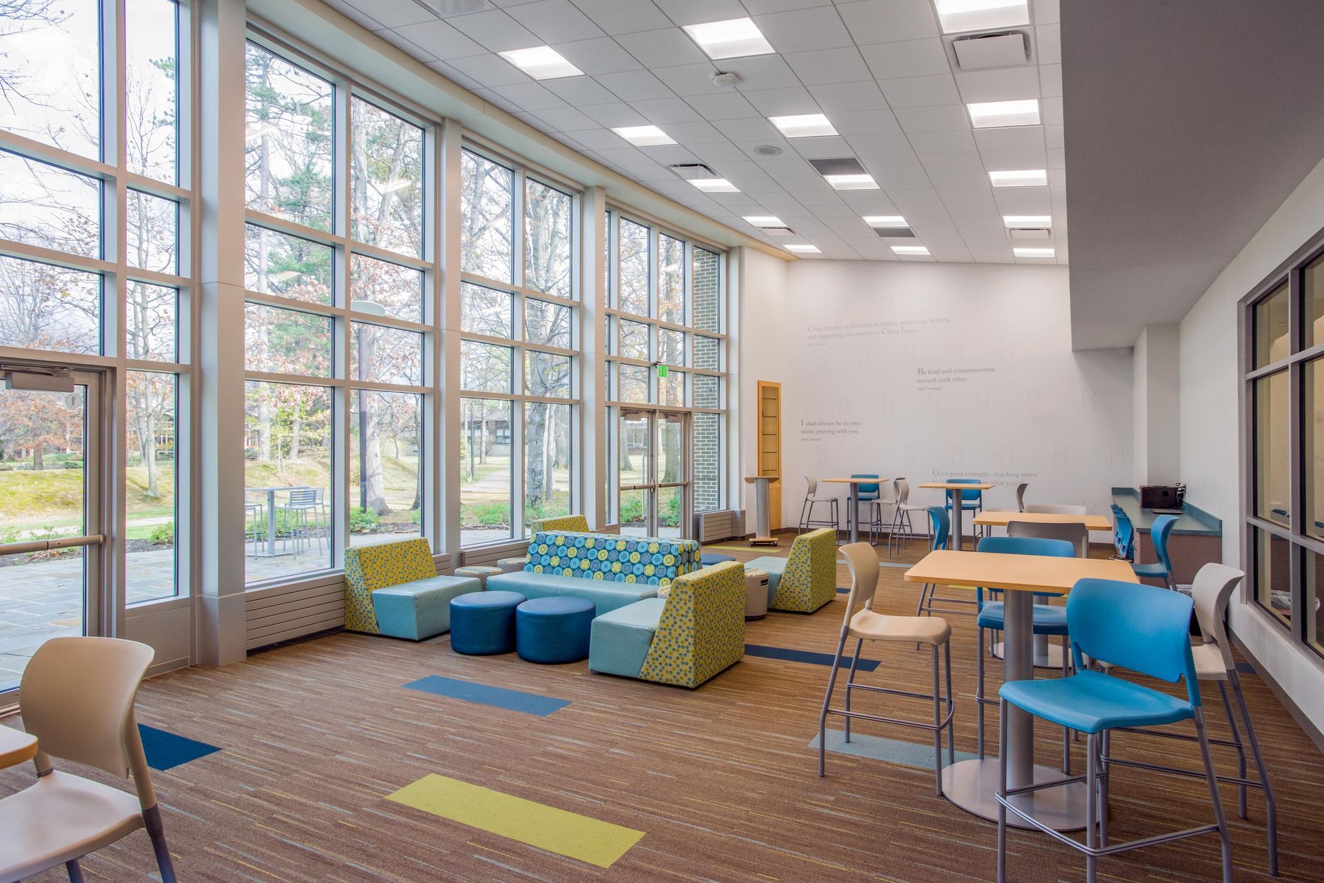 A large room with lots of windows and furniture.