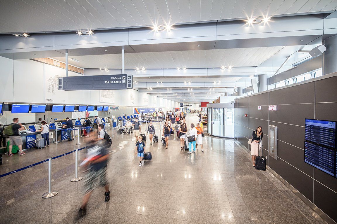 A blurry picture of people walking through an airport.