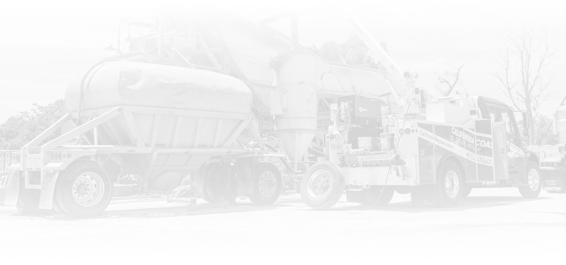 A concrete pumping truck parked outdoors, viewed from the side. | Kensington Motor Cars