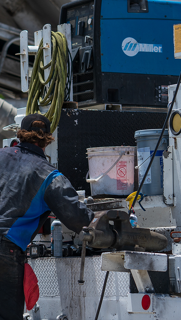 Mechanic with a cap  working with his back to me  | California Coast Truck Repair