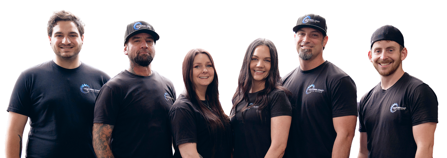 Six people in matching black t-shirts pose against a white background, smiling and facing the camera. | Kensington Motor Cars
