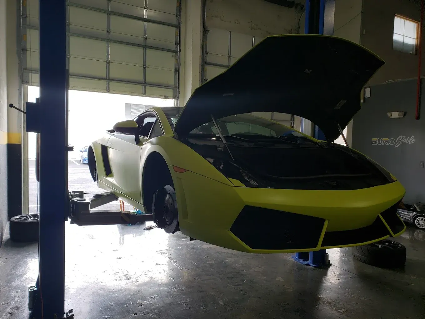 green car in the shop