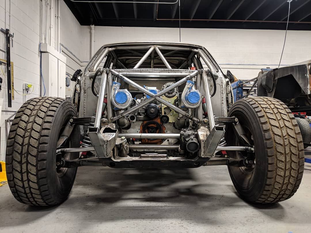 A dirt truck is being built in a garage.