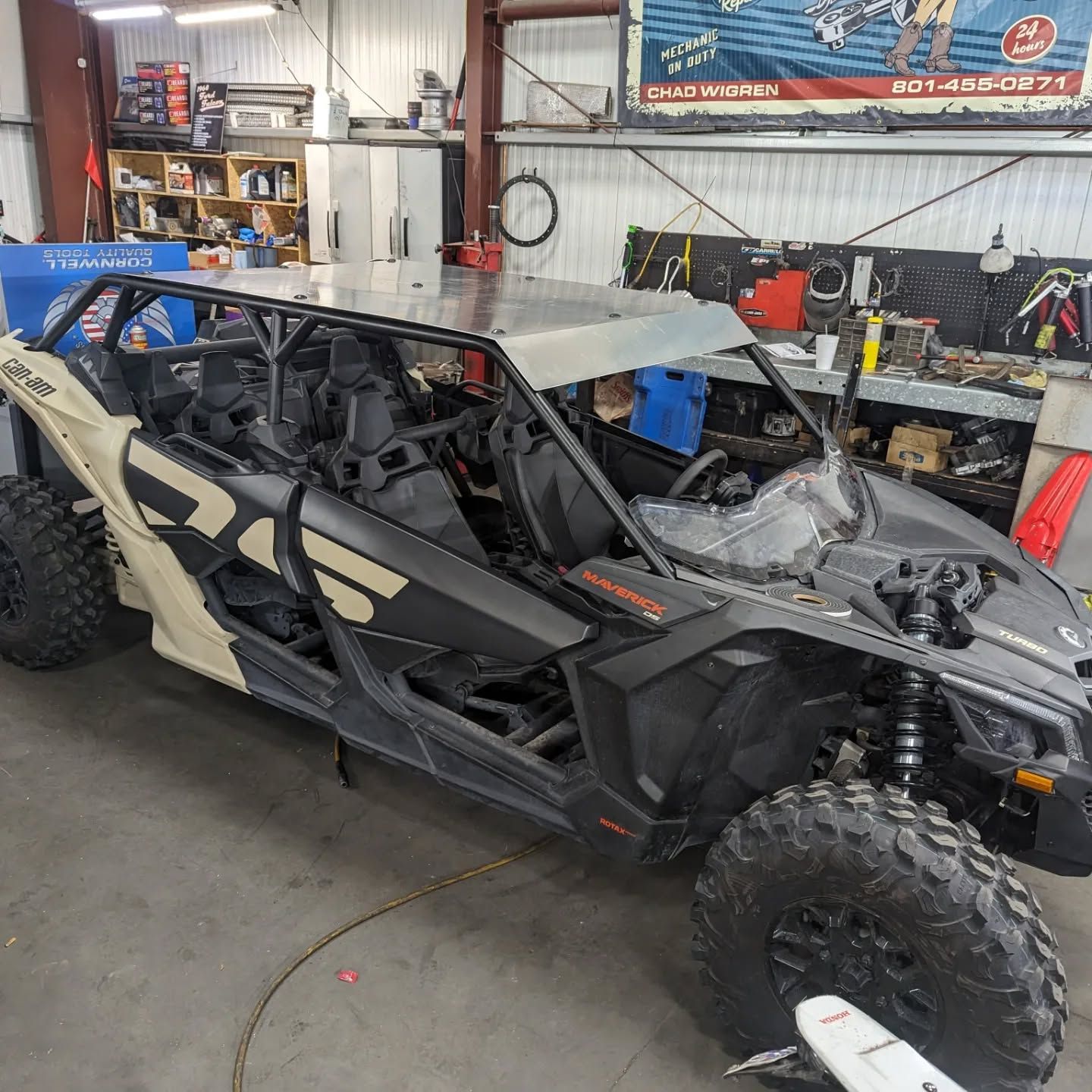 A black and white atv is parked in a garage.