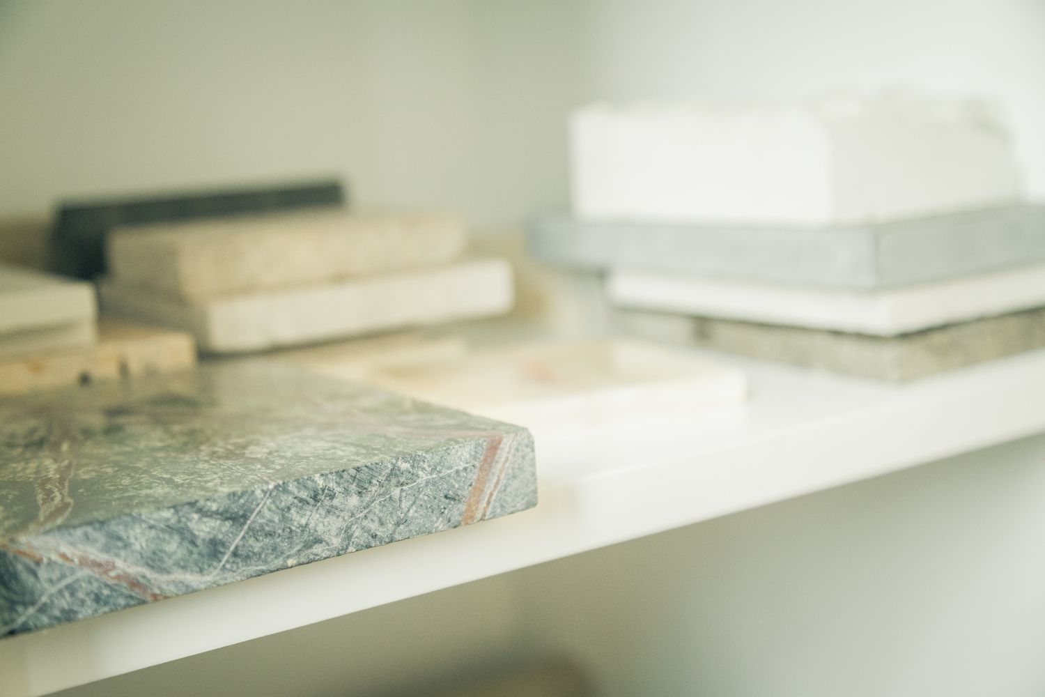A shelf with a stack of marble slabs on it.