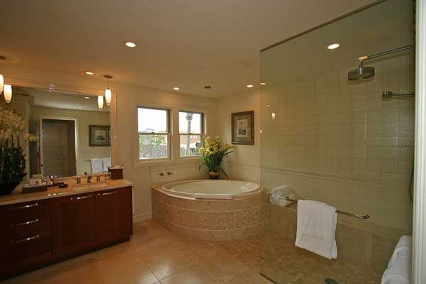 A bathroom with a jacuzzi tub and a walk in shower.
