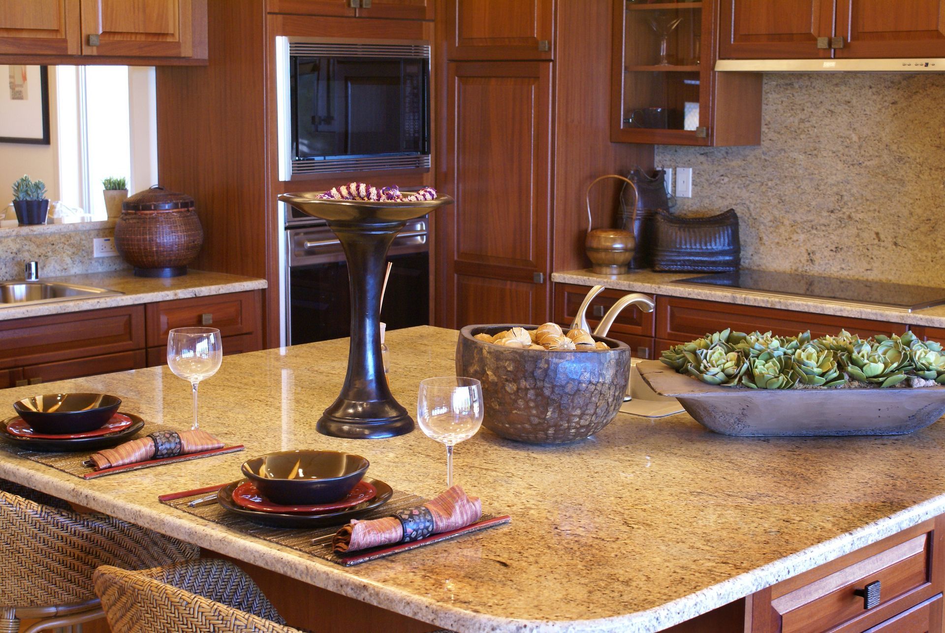 A kitchen with granite counter tops and wooden cabinets