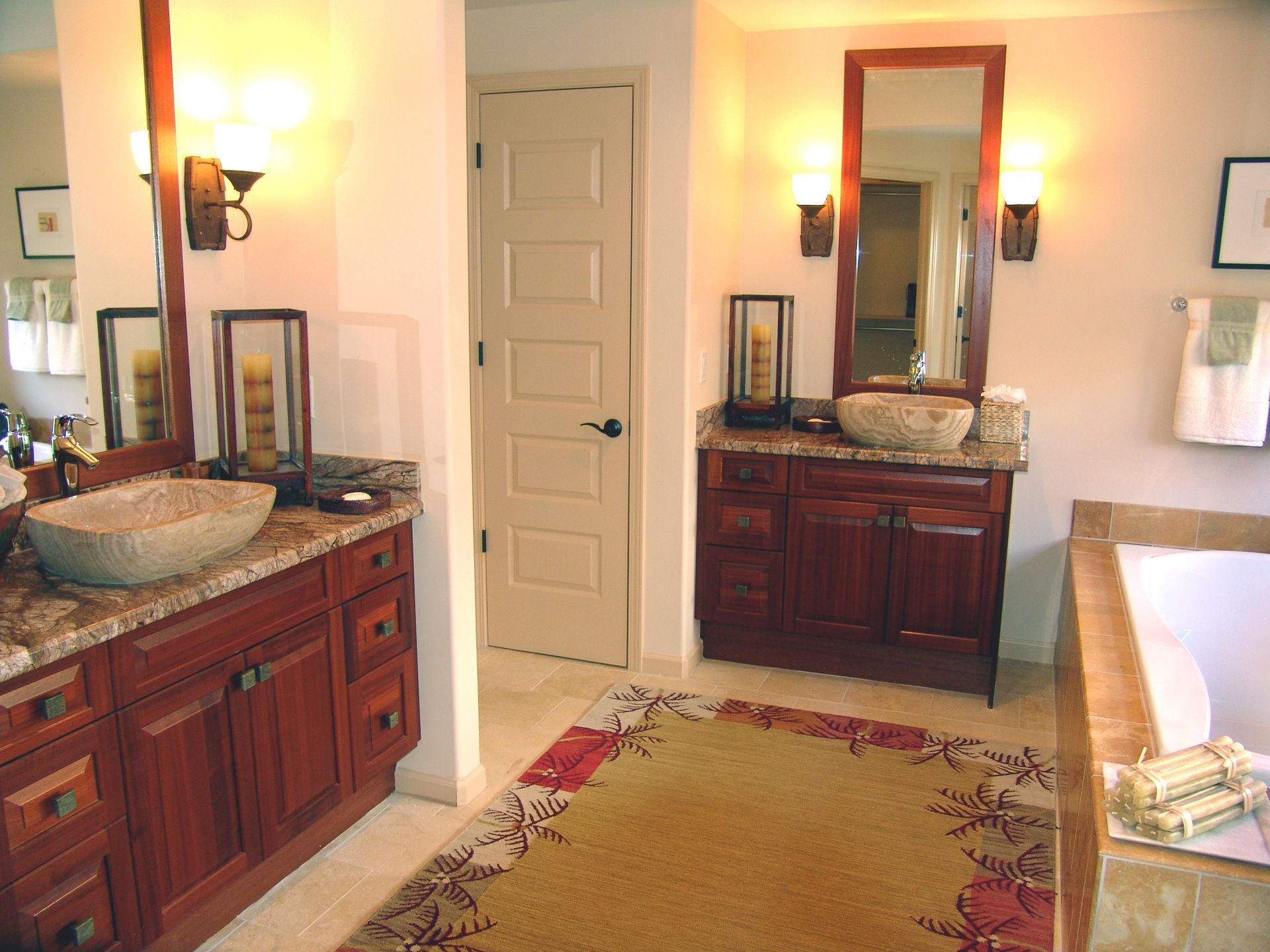 A bathroom with two sinks and two mirrors