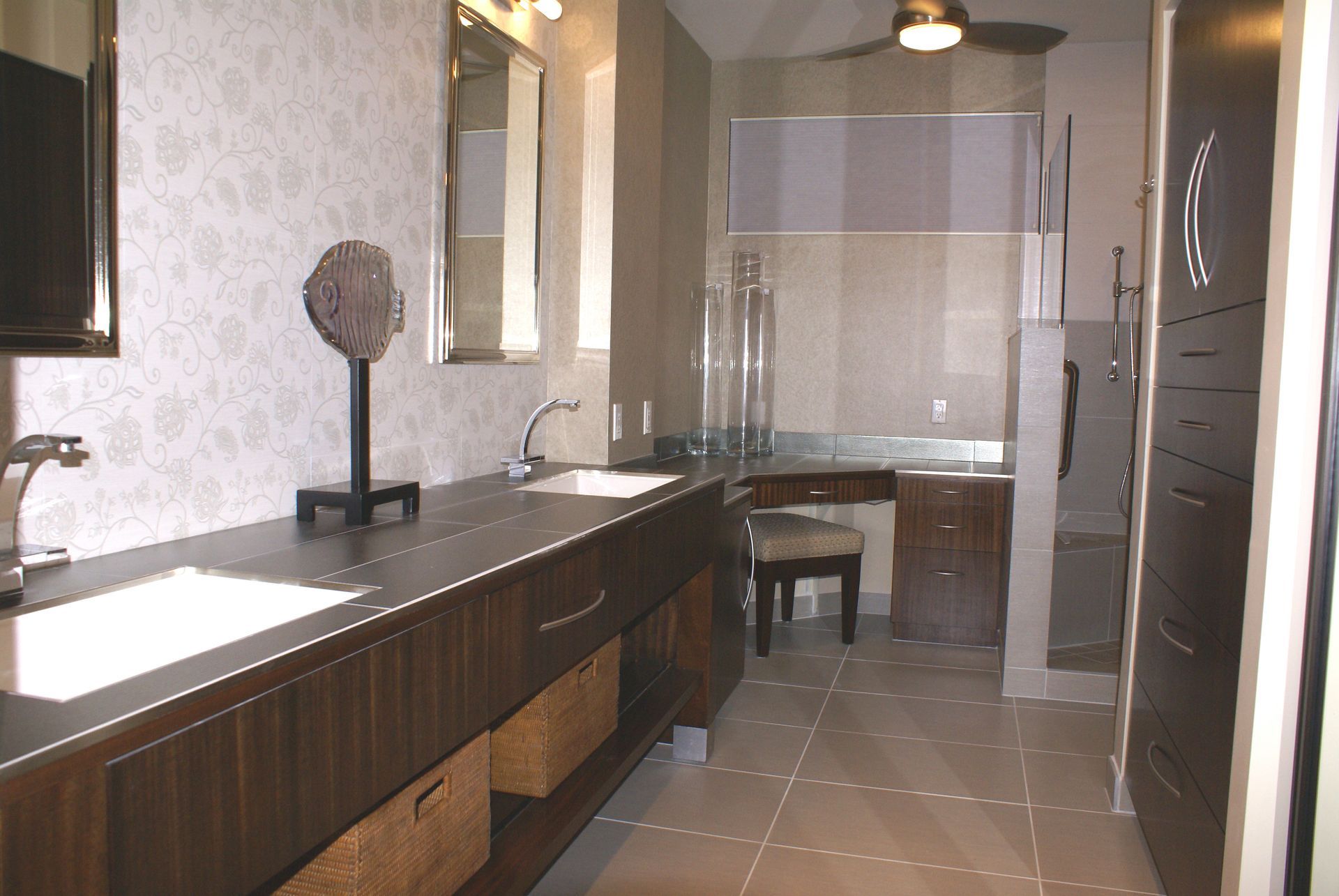 A bathroom with two sinks and a ceiling fan
