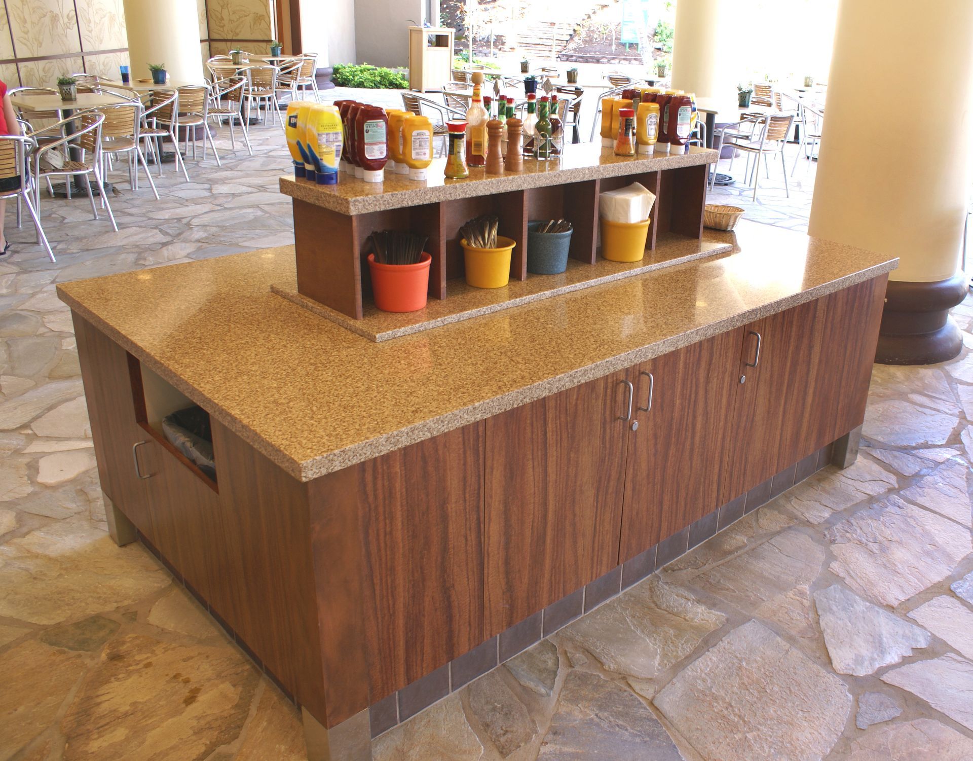 A counter with buckets of syrup on it in a restaurant