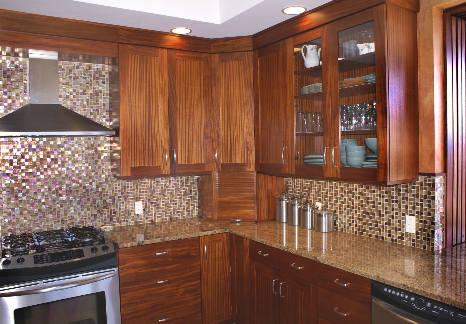 A kitchen with stainless steel appliances and wooden cabinets