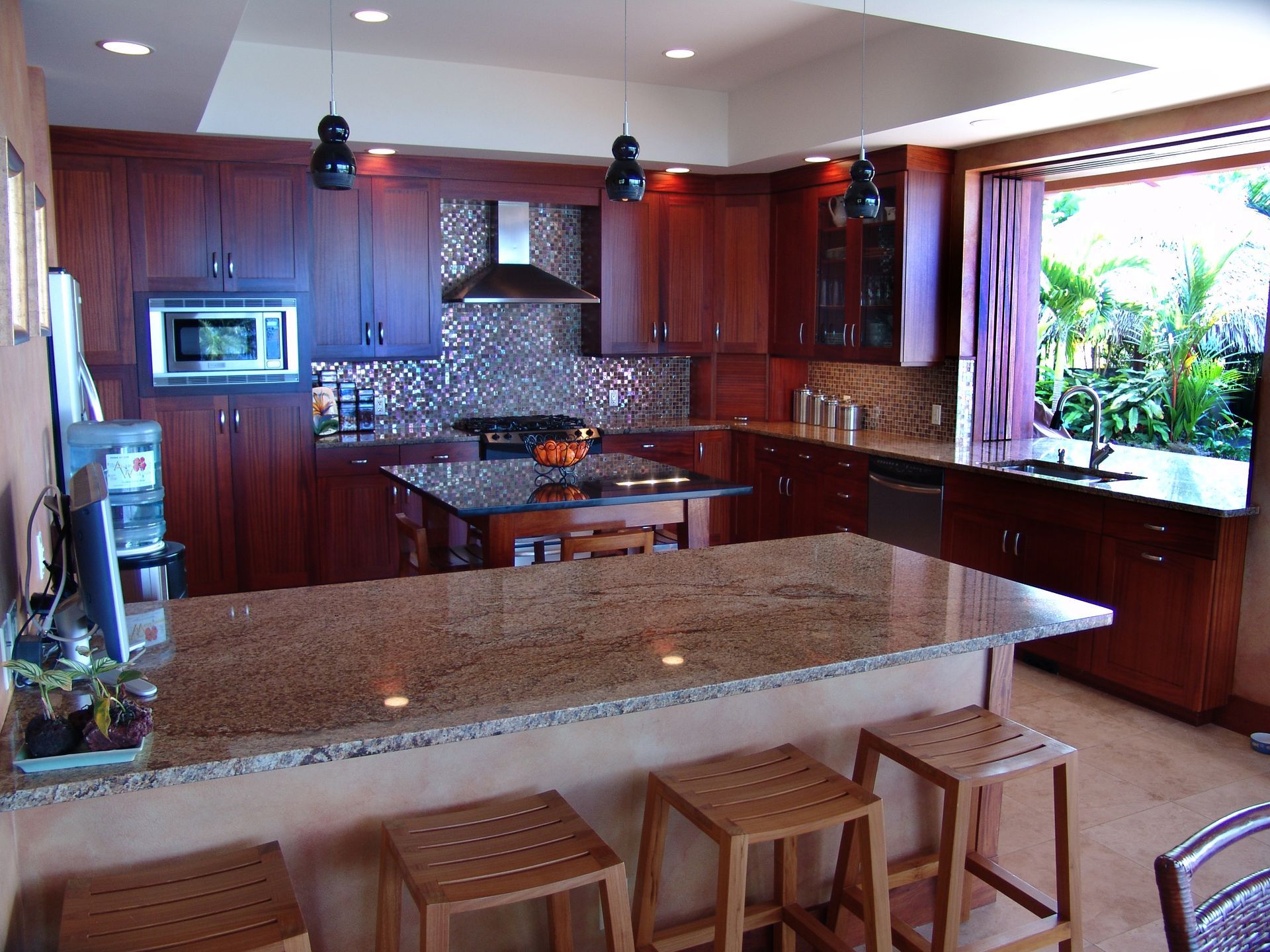 A kitchen with granite counter tops and wooden cabinets