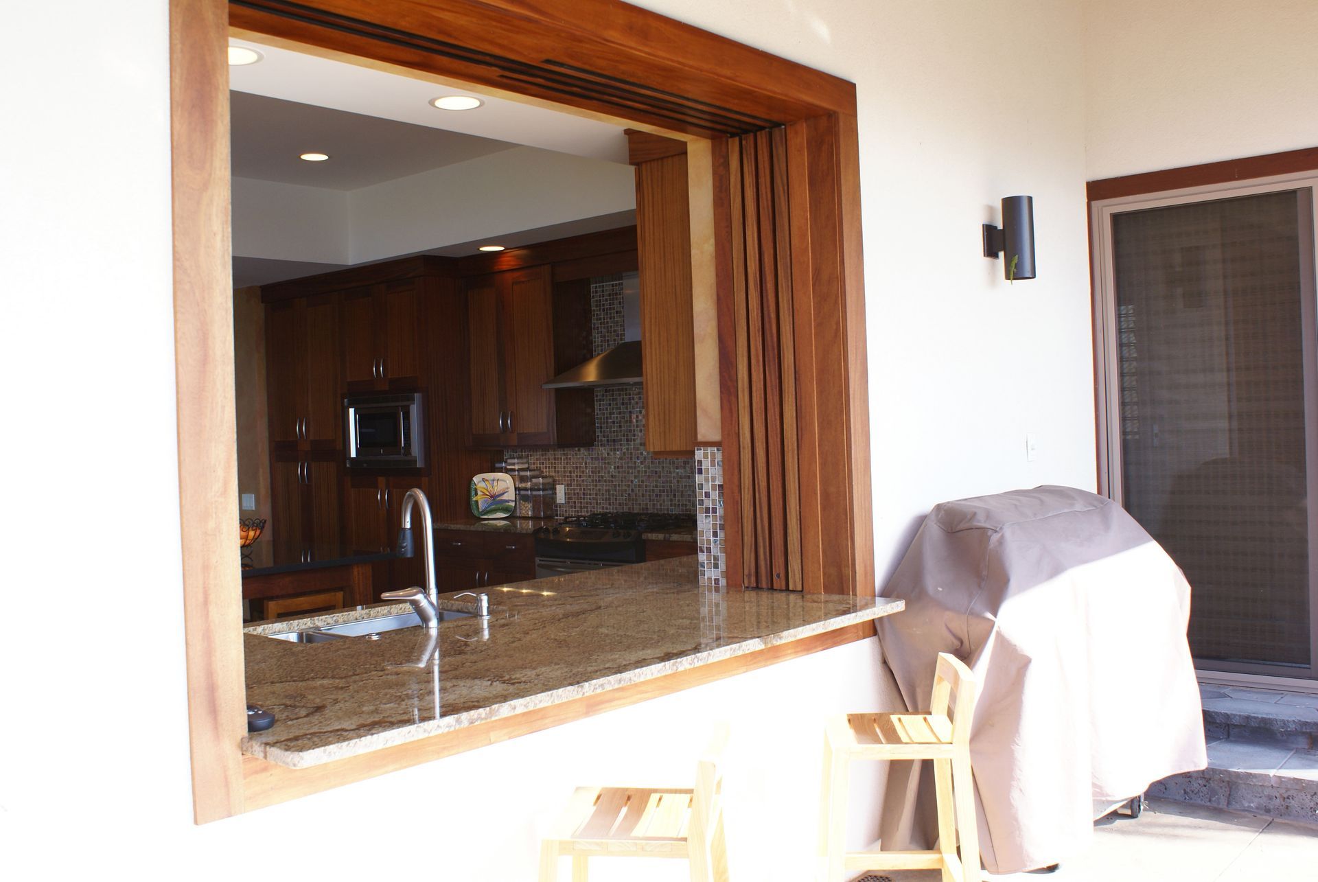 A view of a kitchen through a large window
