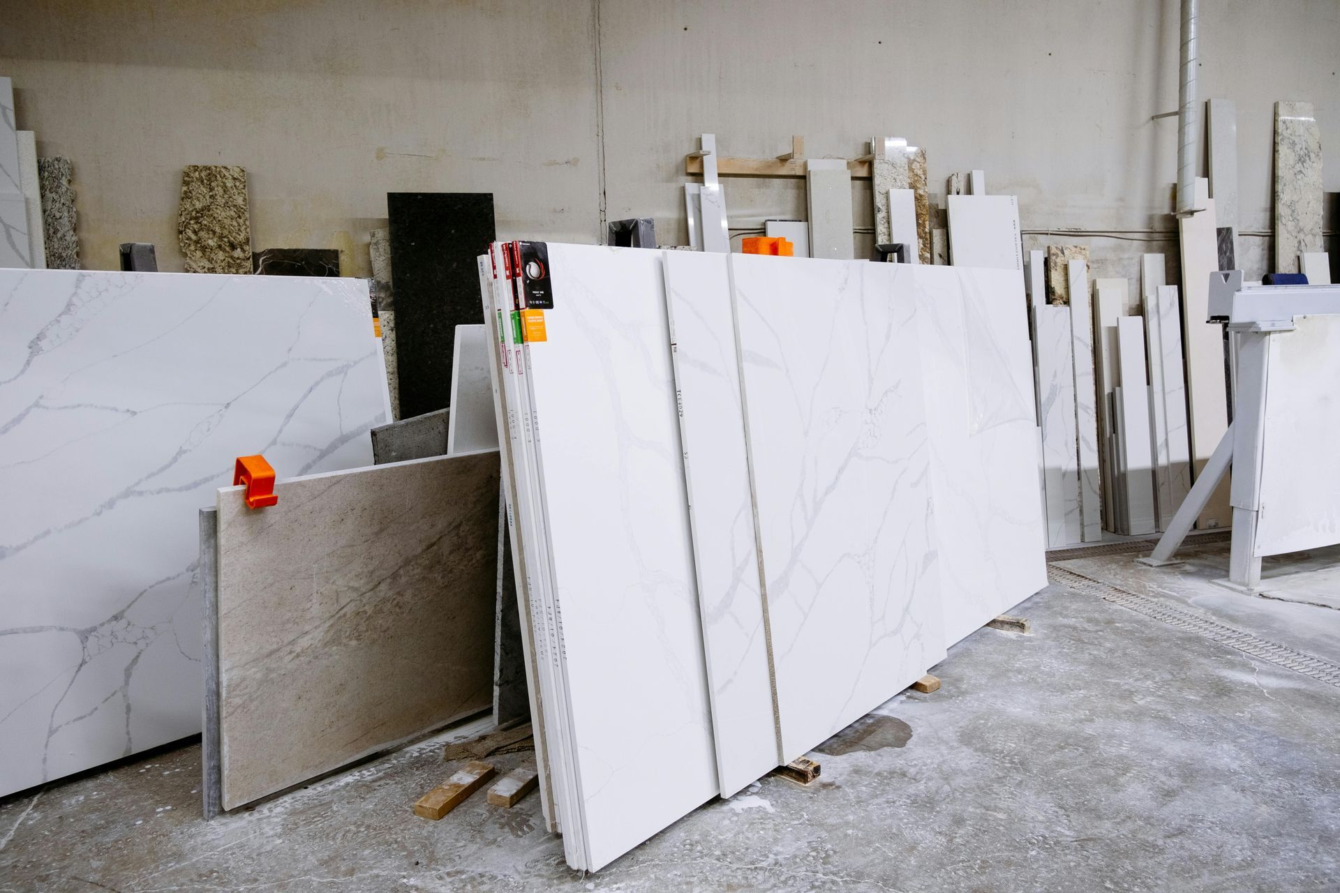 A warehouse filled with lots of white marble slabs.