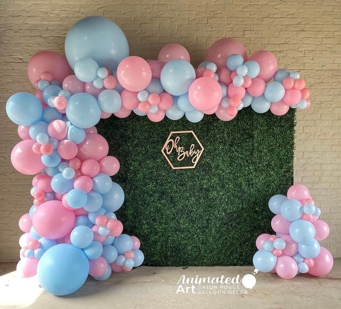 Pink and Blue balloons with green back drop