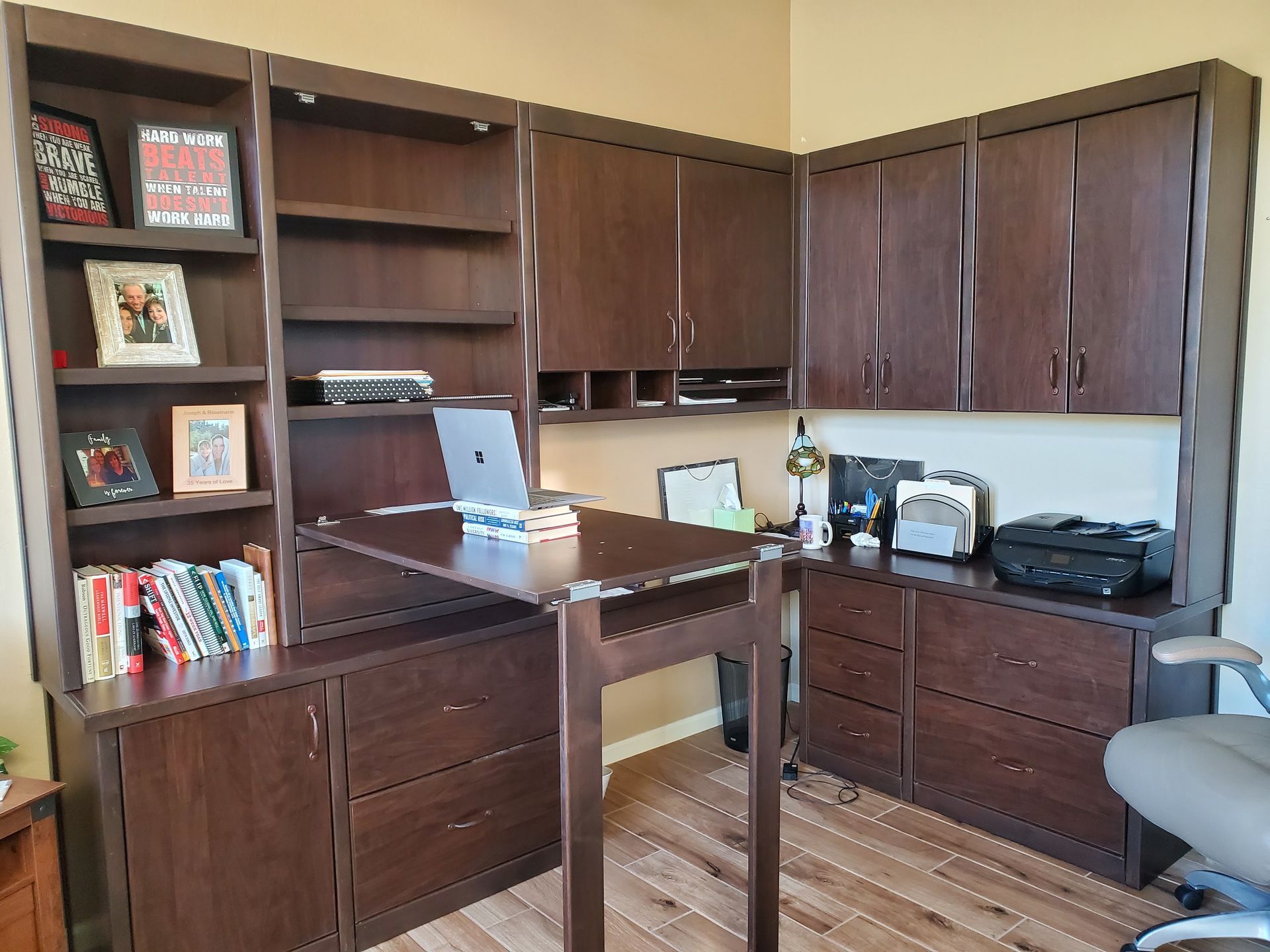A desk with a laptop on it in a home office