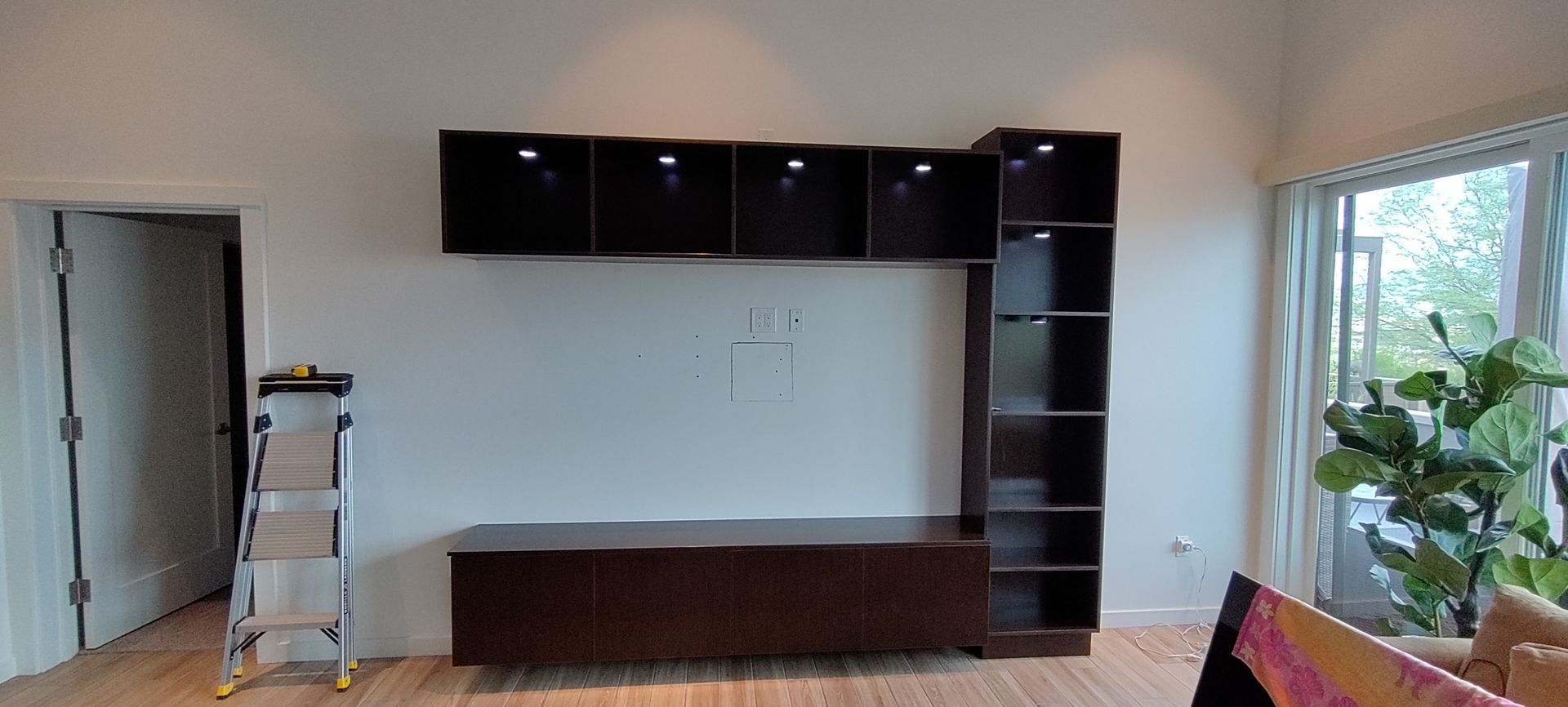 A living room with a ladder in the middle of it