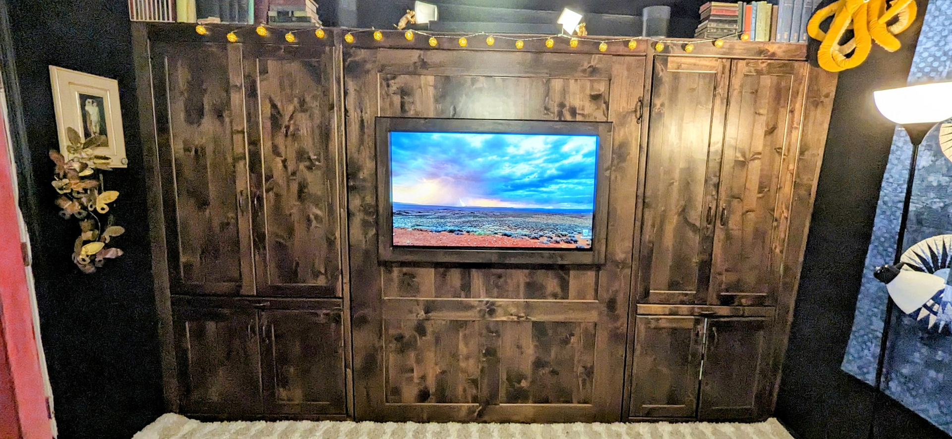 A wooden wall with a flat screen tv mounted on it.