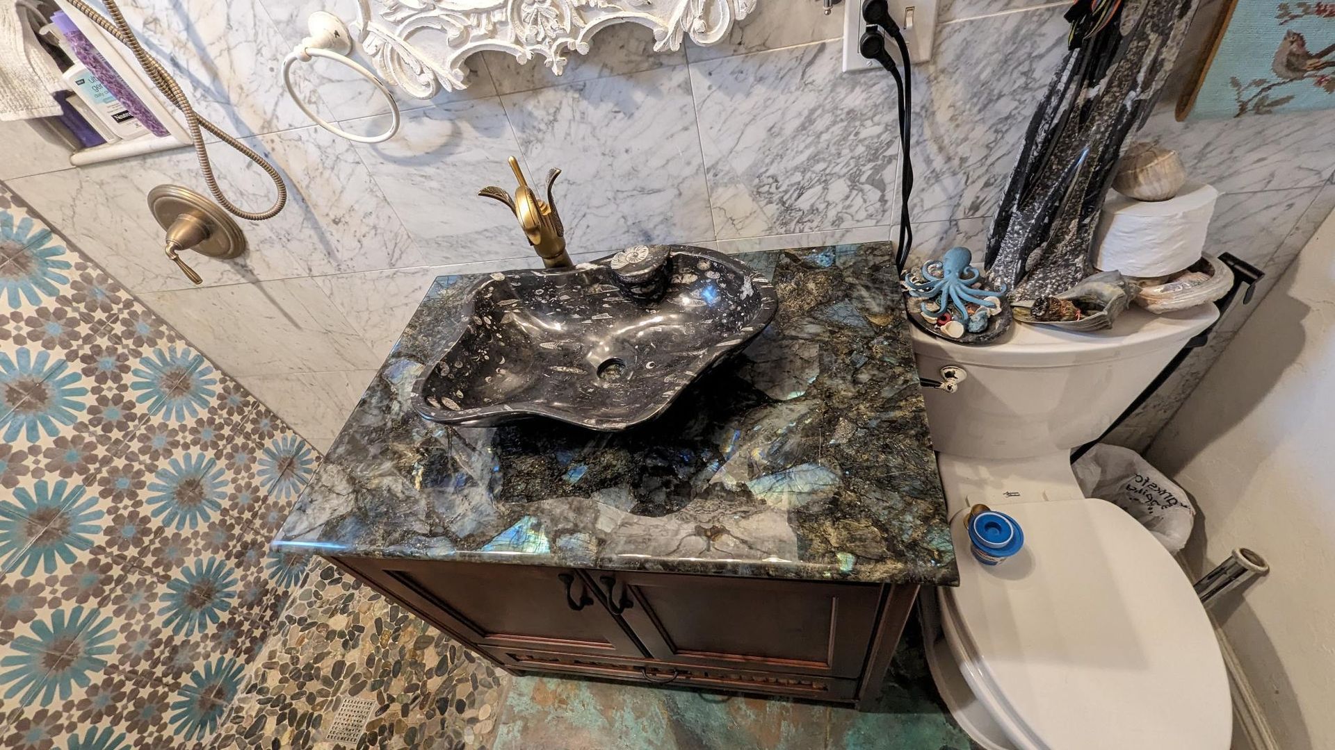 A bathroom with a sink , toilet and mirror.