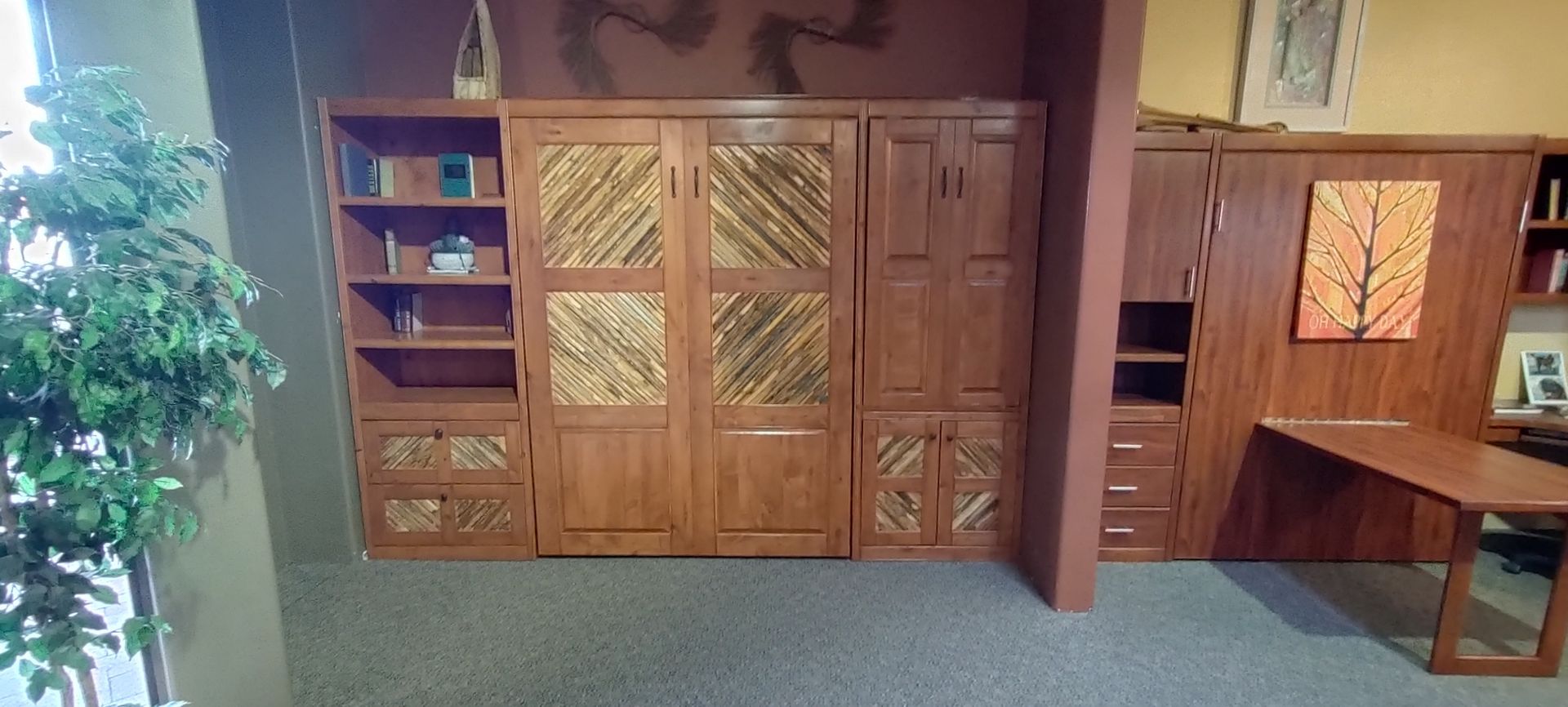 A room with a lot of wooden cabinets and a desk