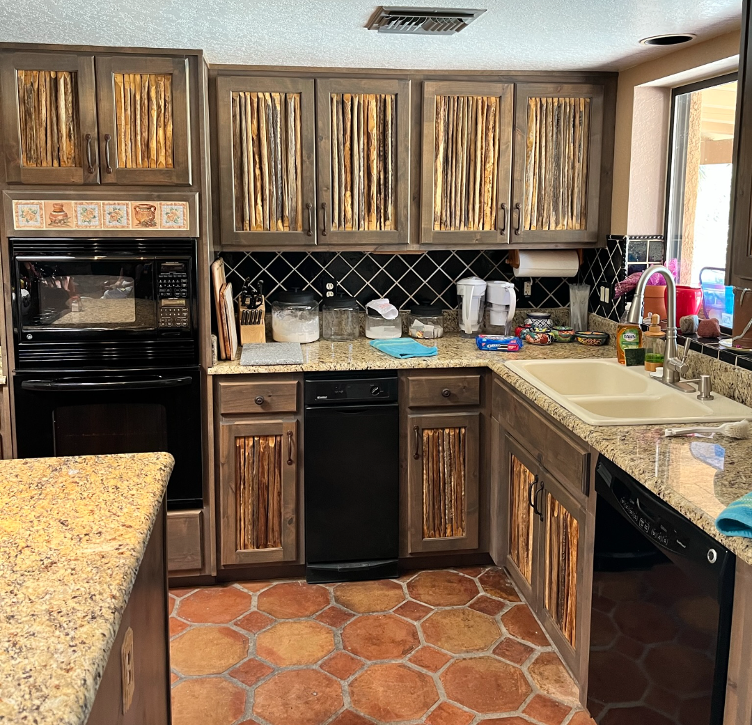 A kitchen with wooden cabinets and granite counter tops