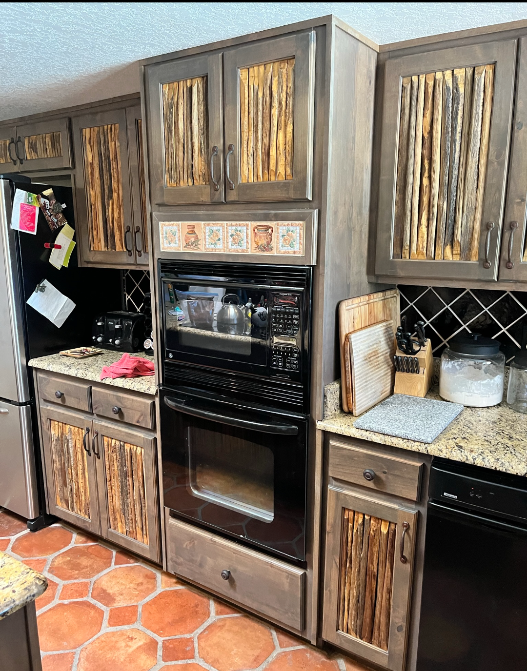 A kitchen with stainless steel appliances and wooden cabinets