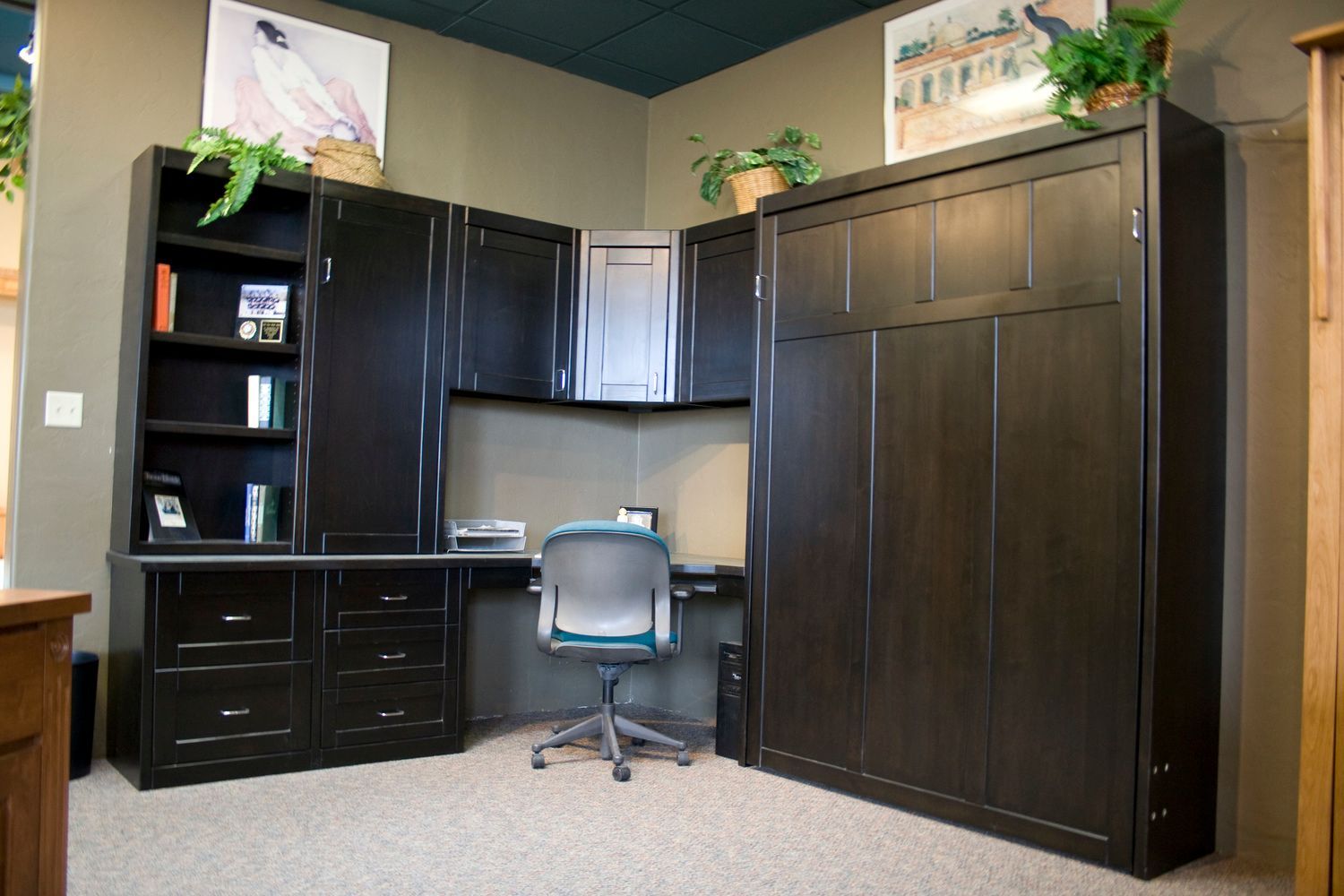 A corner of a room with a desk and chair