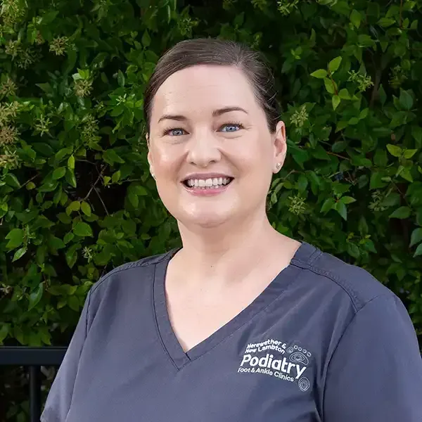 Newcastle podiatrist team member smiling in clinic uniform