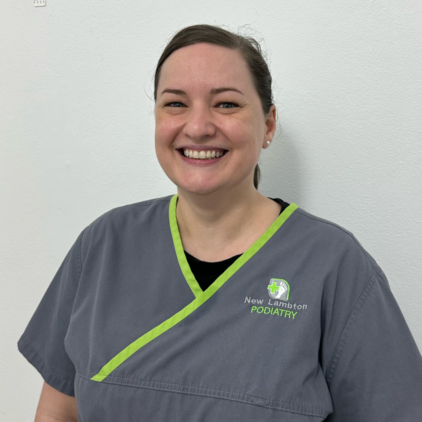 Newcastle podiatrist team member smiling in clinic uniform