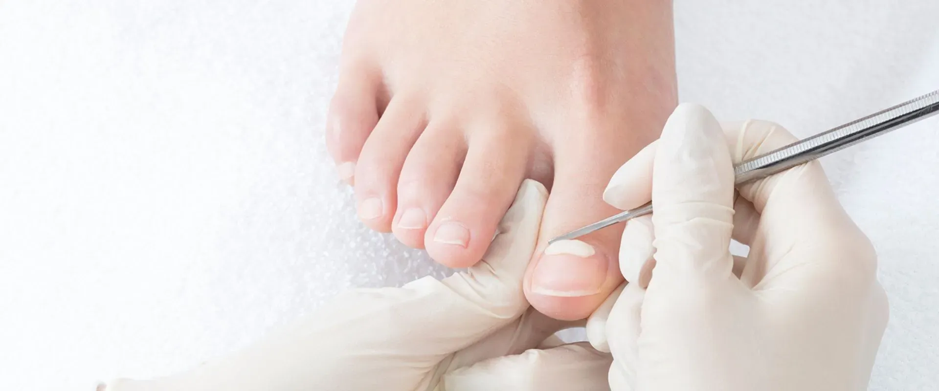 A person is getting their toenails trimmed by a nail technician.