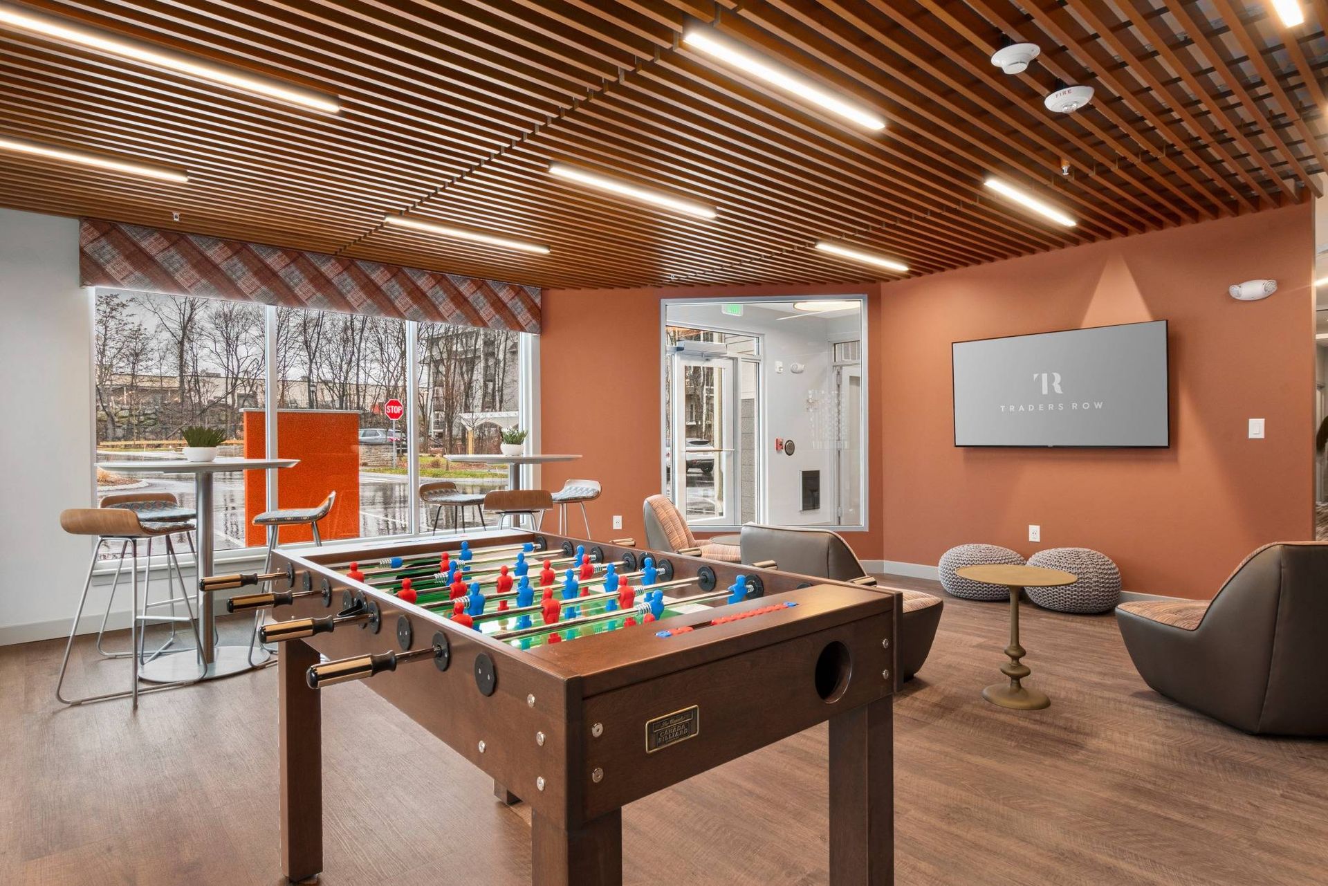 Traders Row entertainment lounge with foosball and designer lighting.