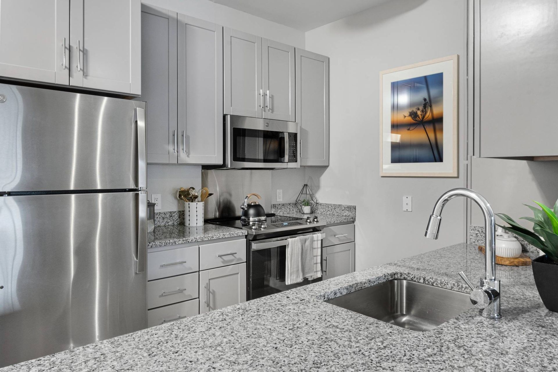 Traders Row chef-inspired kitchen with light grey cabinets and countertops. 