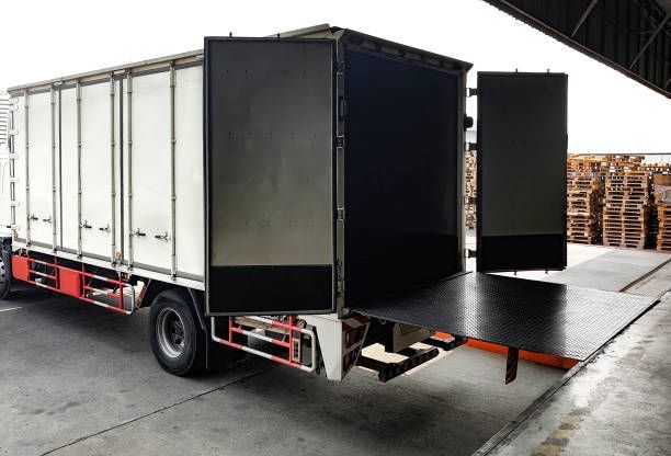 Delivery truck with open rear doors and loading platform.