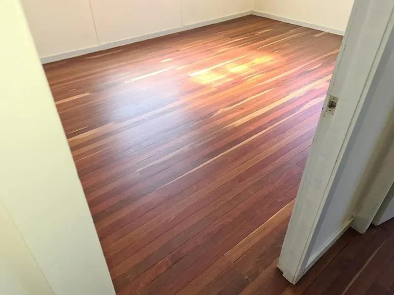 A Wooden Floor in a Room With a Door Open — Alan Aldridge Floor Sanding in Urraween, QLD