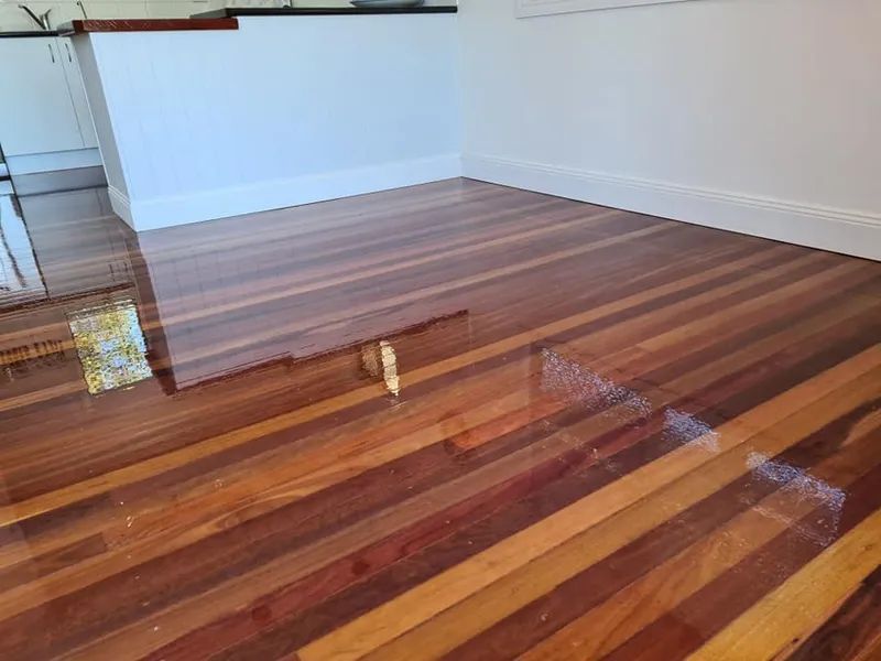 A Room With a Wooden Shiny Floor and a White Wall — Alan Aldridge Floor Sanding in Urraween, QLD