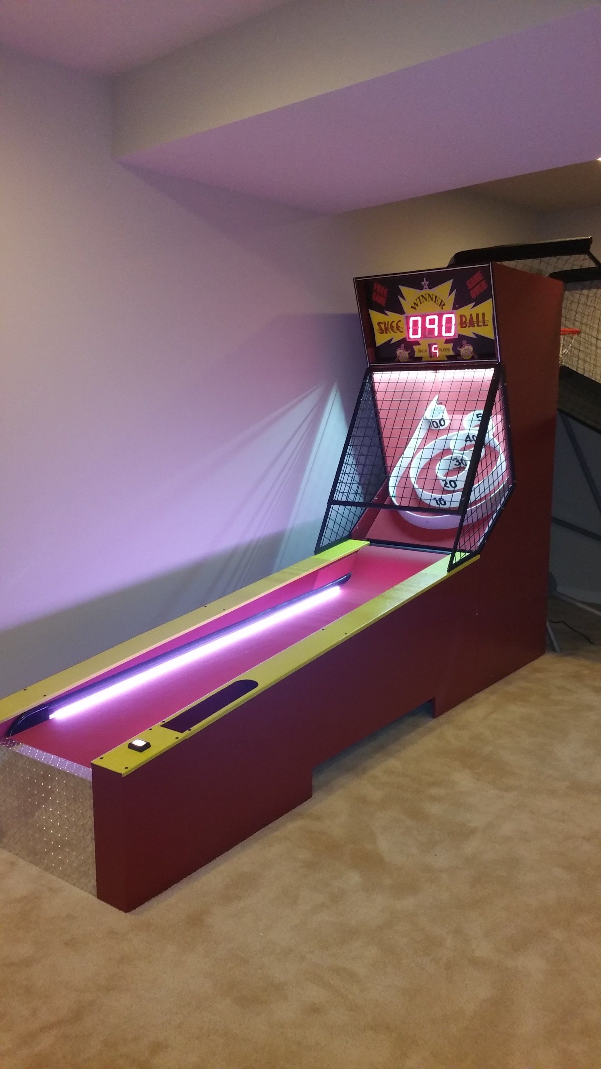 There is a bowling alley in the corner of the room.