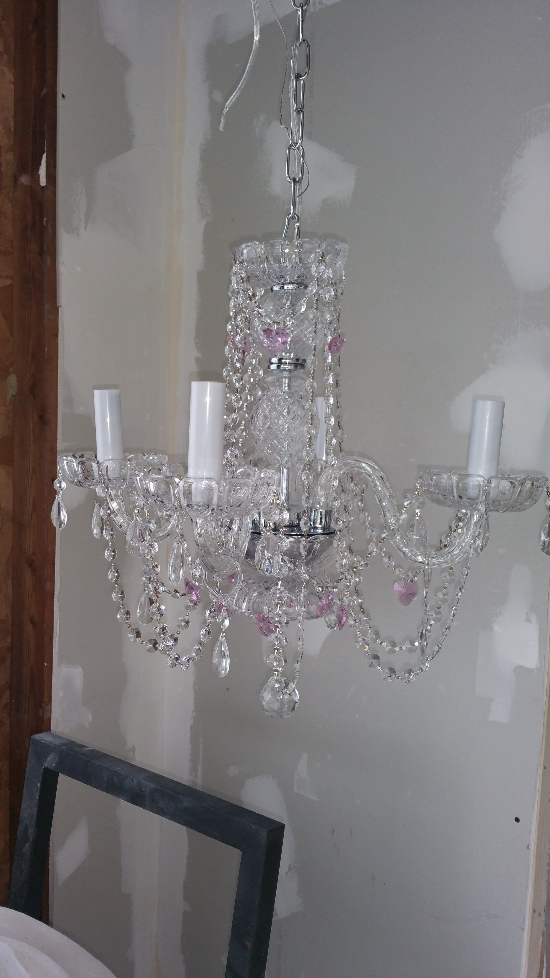 A chandelier is hanging from the ceiling in a room.
