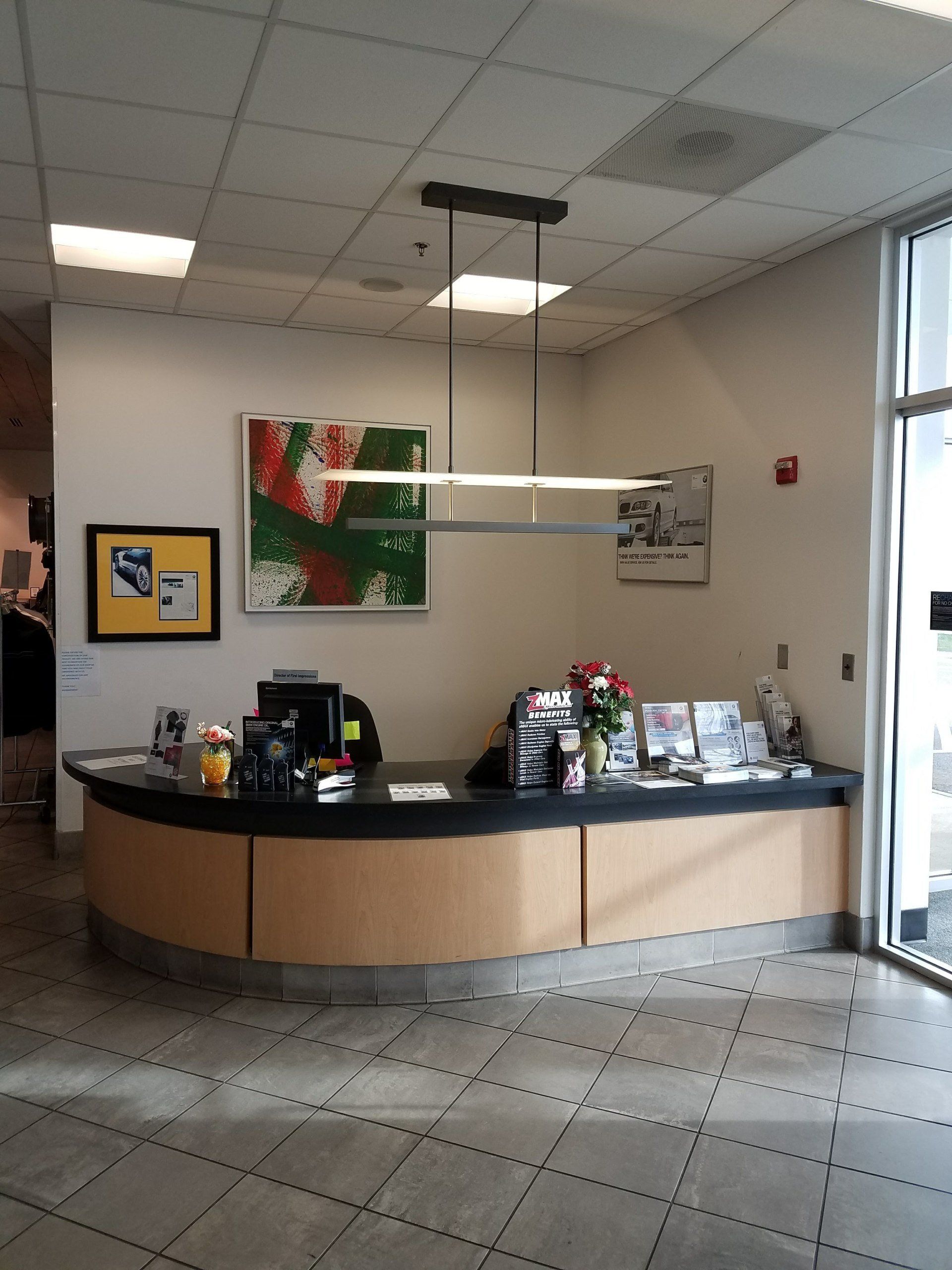 A reception desk with a painting on the wall above it