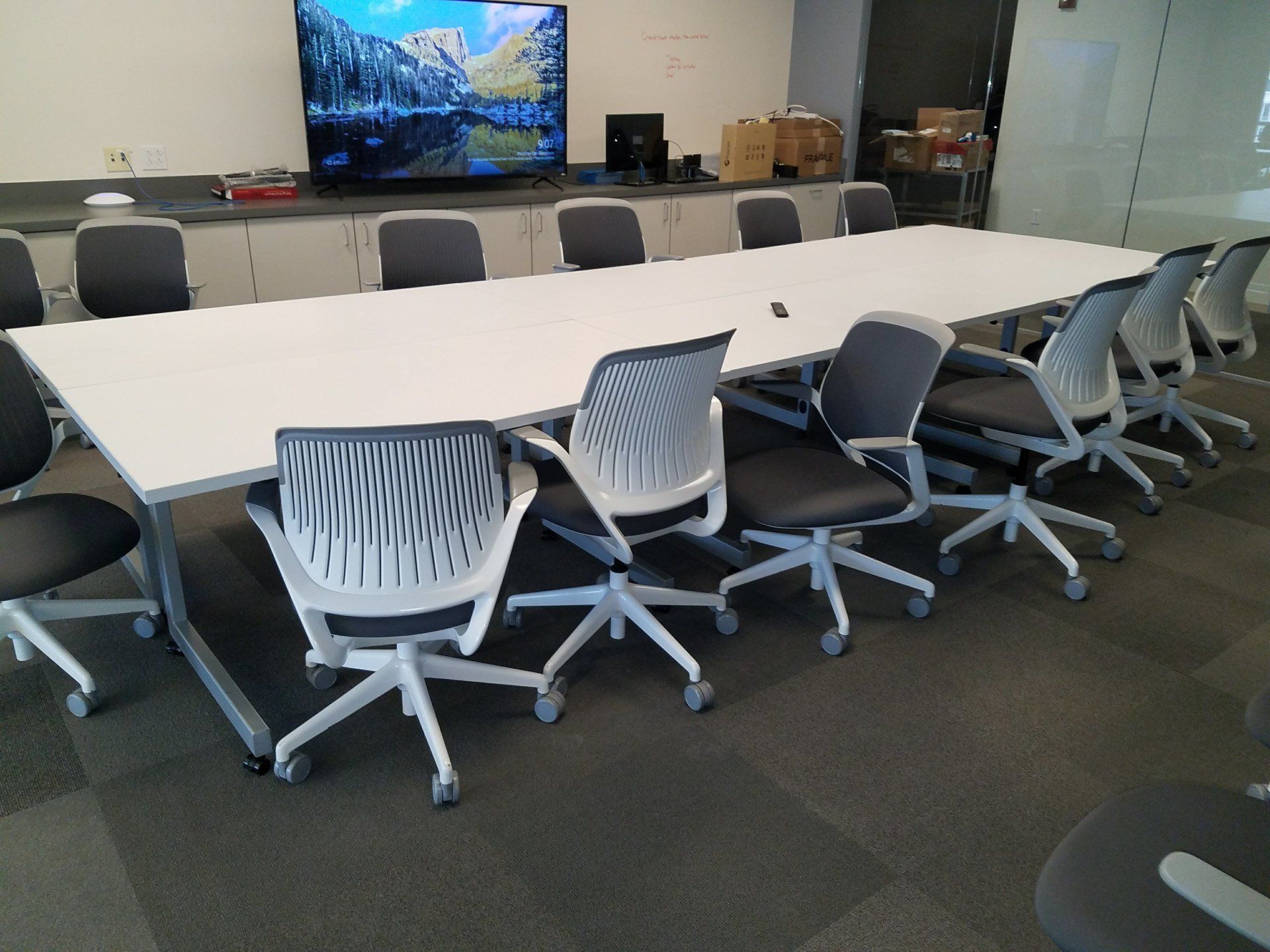 A conference room with a long table and chairs