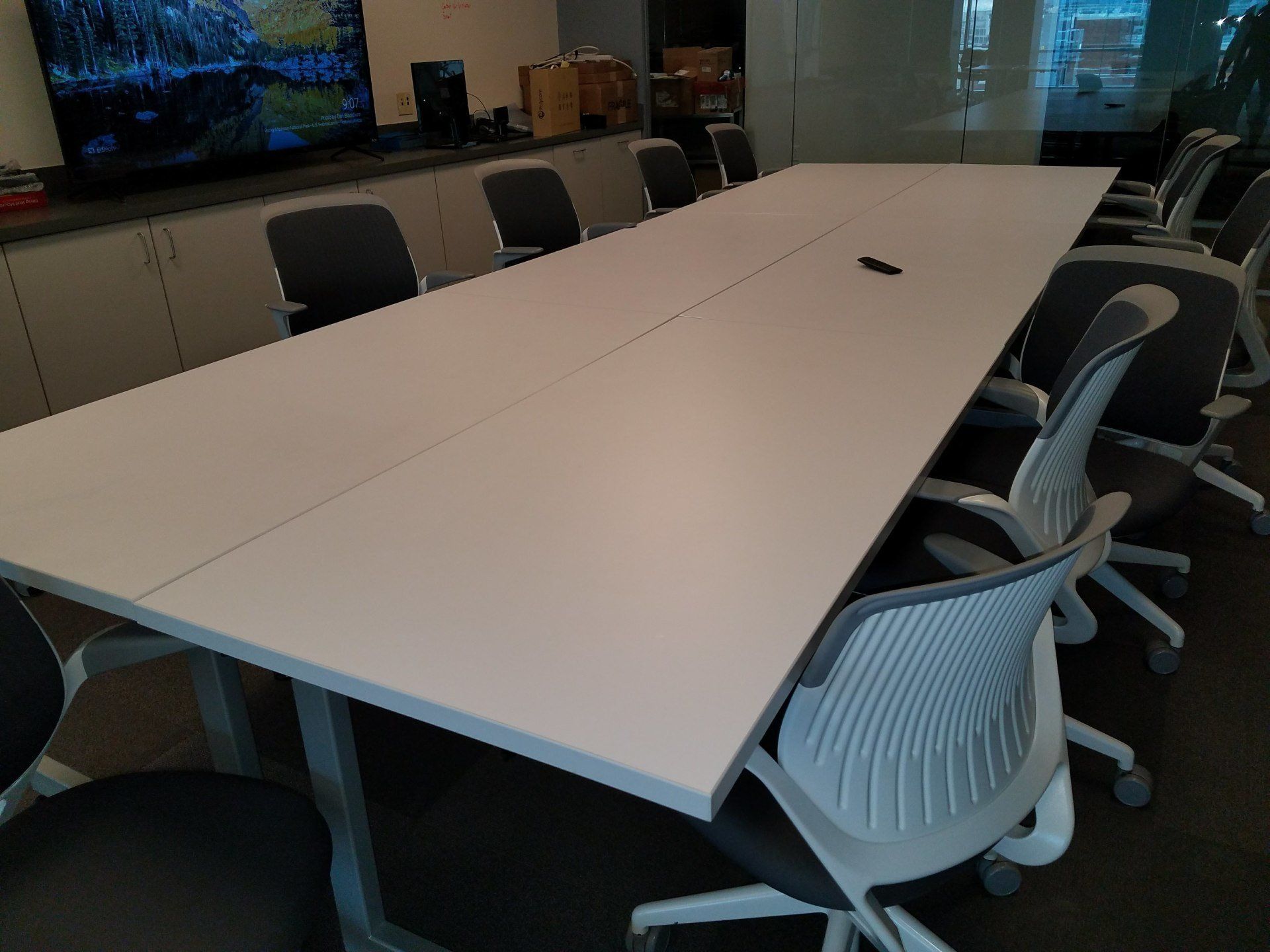 A conference room with a long white table and chairs