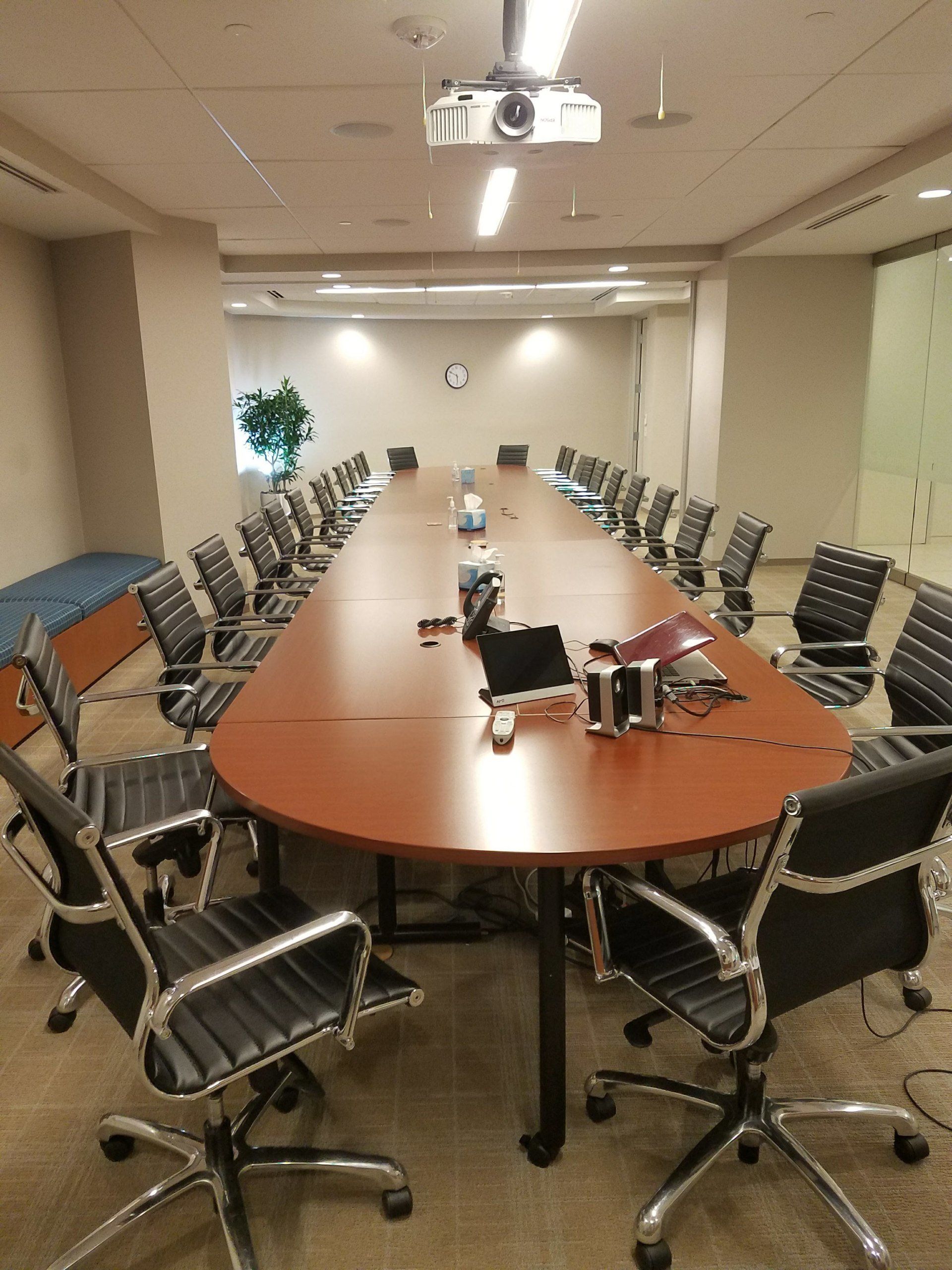 A conference room with a long table and chairs