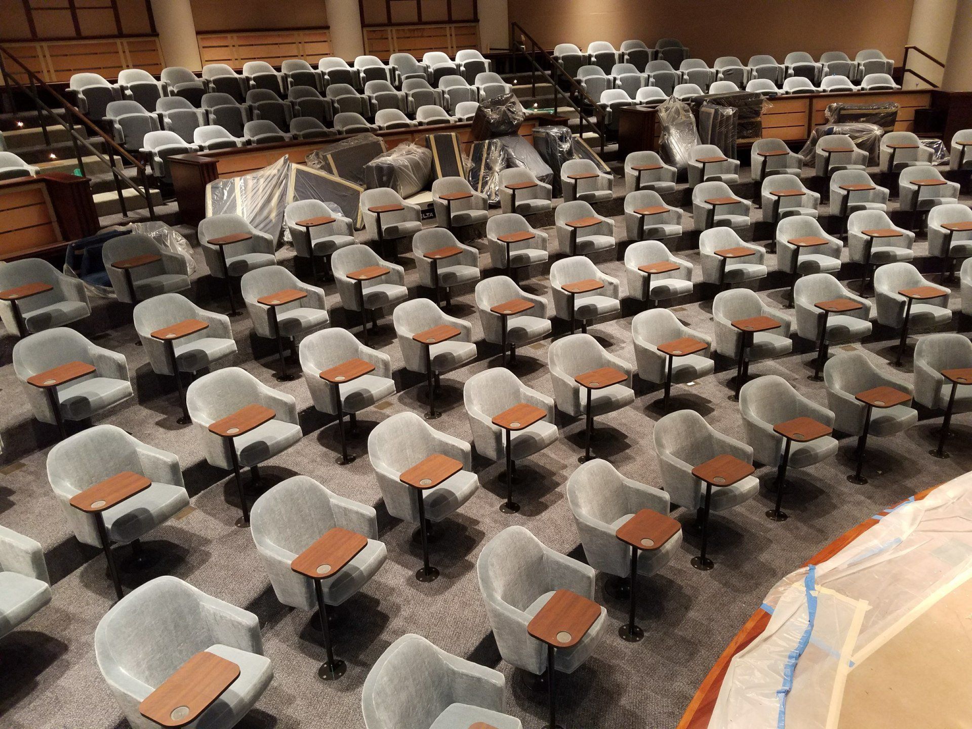 A large auditorium with rows of chairs and tables