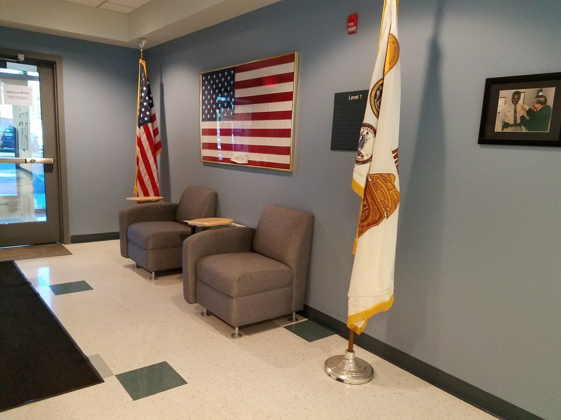 A room with chairs and flags on the wall