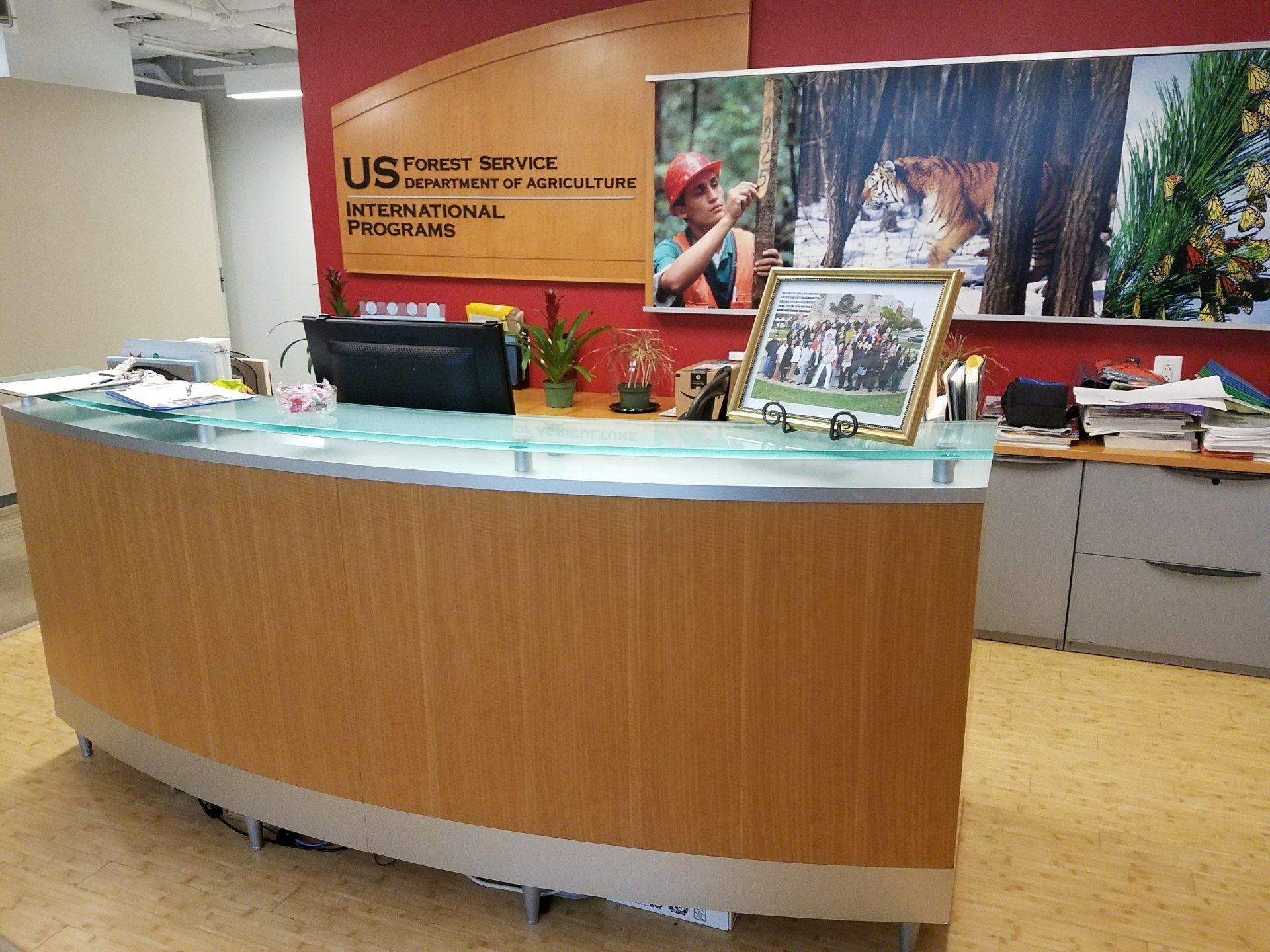 A wooden reception desk with a computer on it