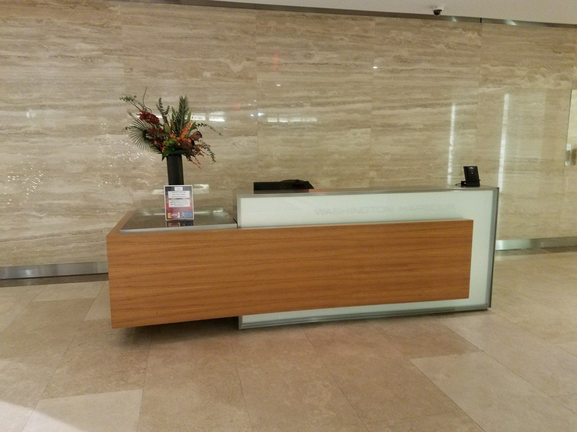 A reception desk with a vase of flowers on it