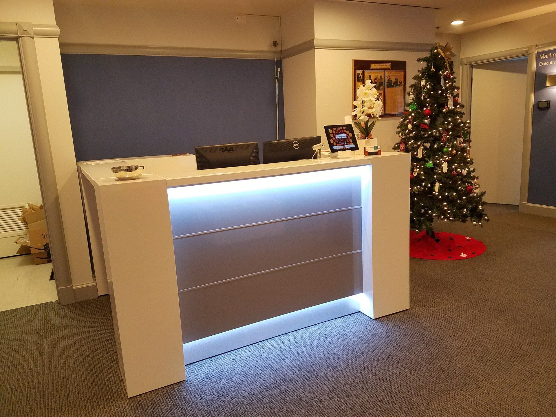 A reception desk with a christmas tree in the background